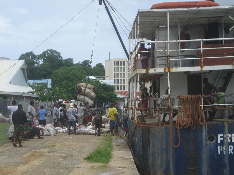 0313 unloading crops market.JPG - coastal trader (rust bucket) unloading